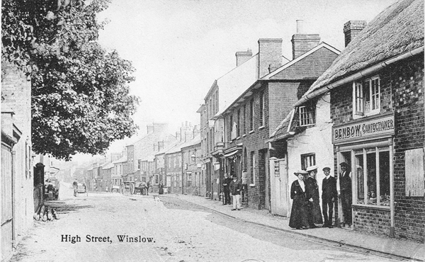 Postcard showing a shop with a sign for F. Benbow Confectioner